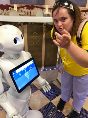 Shona interacts with a robot that has an interactive screen on its chest