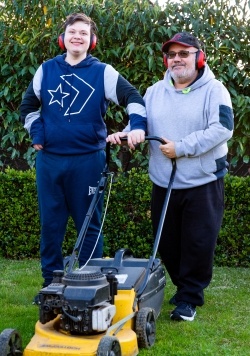 Adam and Darren Kohne mowing the lawn together