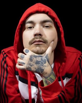 MC Wheels posing for the camera in his red hoodie.