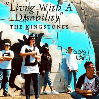 The KingStones posing in front of a wall with the title of their latest single, Living with a disability in the top right hand corner