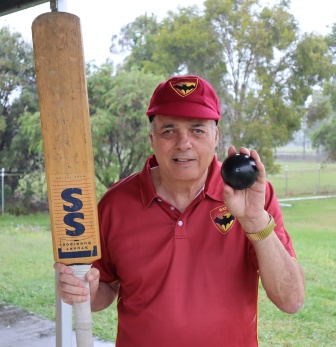 paul in cricket uniform holding bat and ball