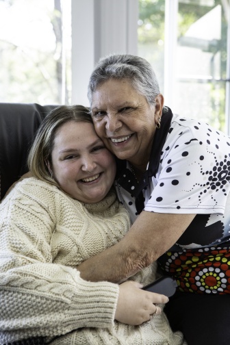 A grinning Tanesha being hugged by her nan Yvonne