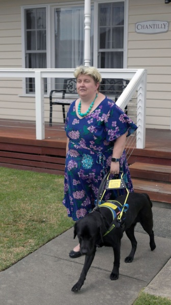 Leah van Poppel with her assistance dog outside 