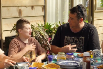 Jeremiah and his dad Joel use key word signing to communicate, while eating breakfast together