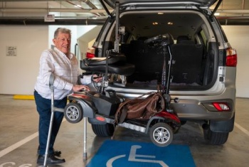 Mike in his accessible car park at work 